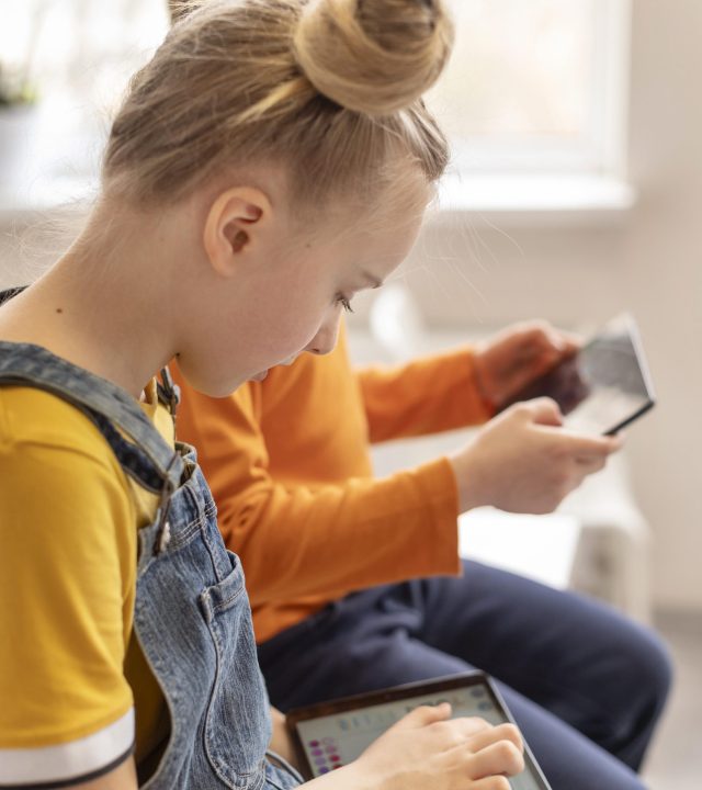 close-up-kids-learning-with-devices